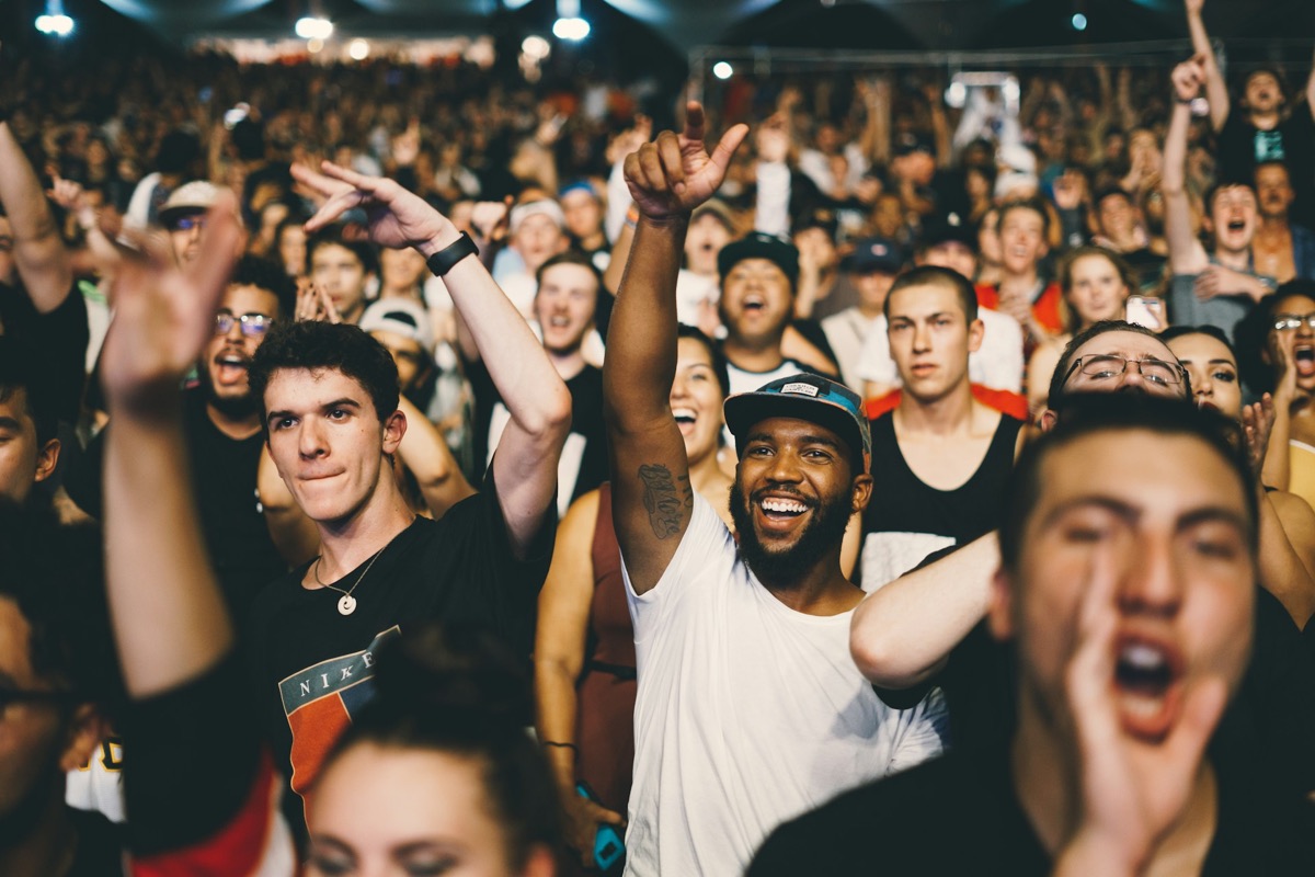 A crowd celebrating at a live concert